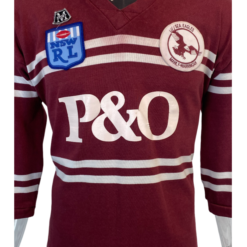 Close up of the front of a 1990 Vintage Manly Sea Eagles Jersey with P&O , NRL and manly logo
